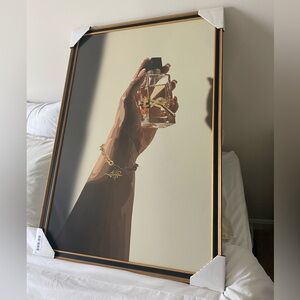 2 Black and gold wooden poster frames.